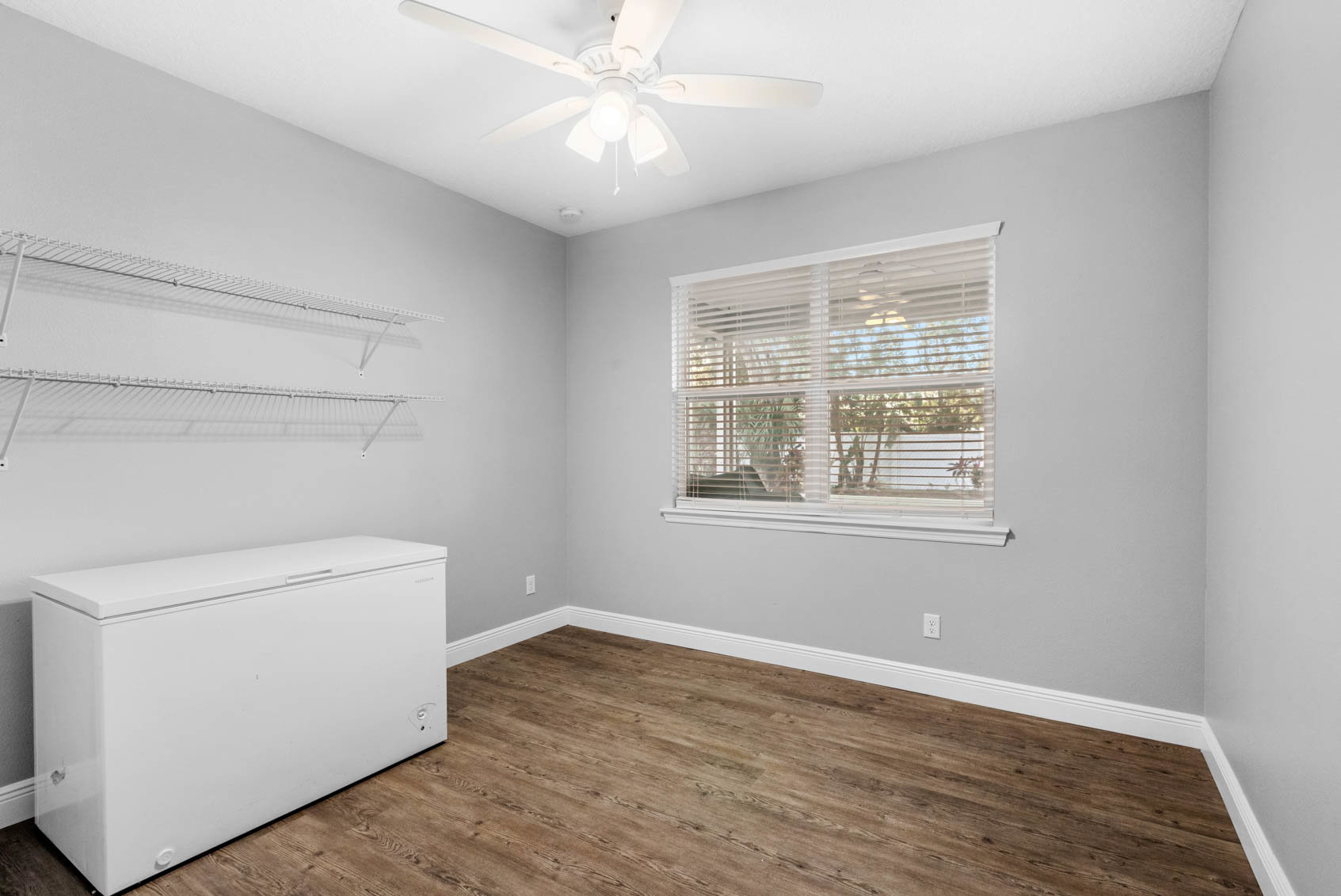empty bedroom with white deep freeze